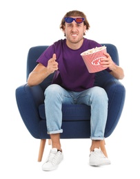 Photo of Emotional man with 3D glasses and popcorn sitting in armchair during cinema show on white background