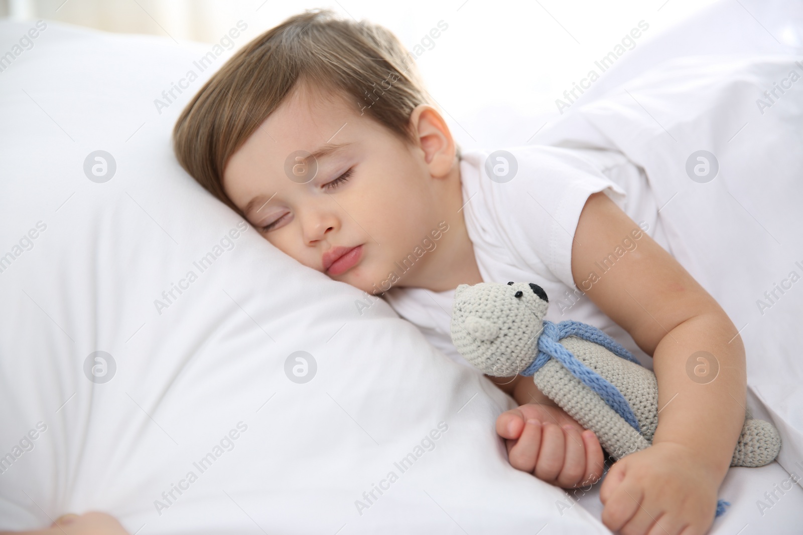 Photo of Cute little baby sleeping with toy at home. Bedtime