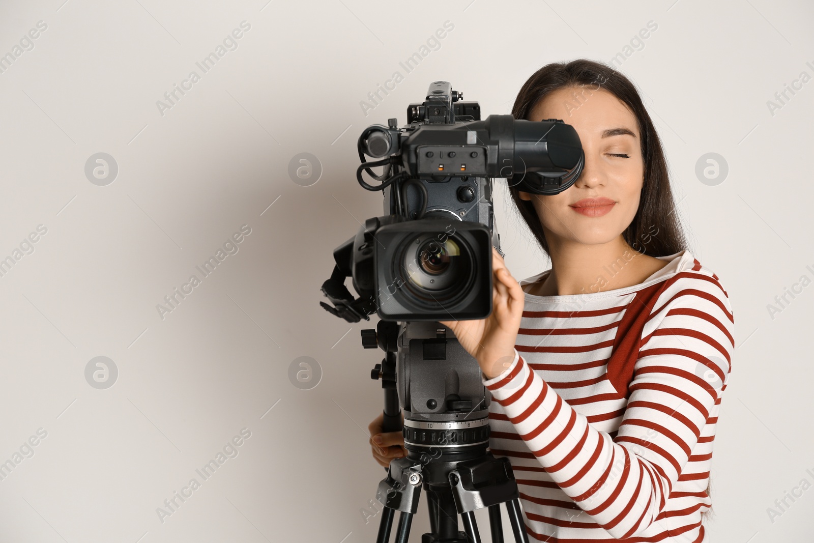 Photo of Operator with professional video camera on white background