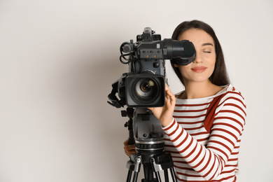 Photo of Operator with professional video camera on white background