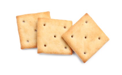 Photo of Tasty crispy square crackers isolated on white, top view