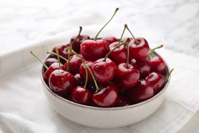 Photo of Fresh ripe cherries with water drops on towel, closeup