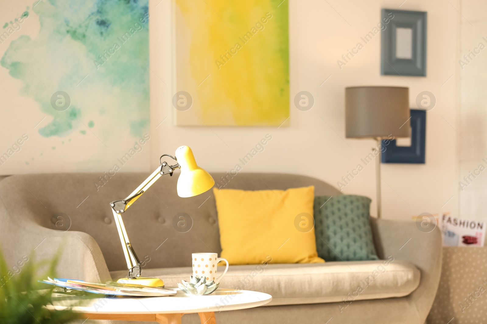 Photo of Room interior with modern desk lamp and comfortable sofa