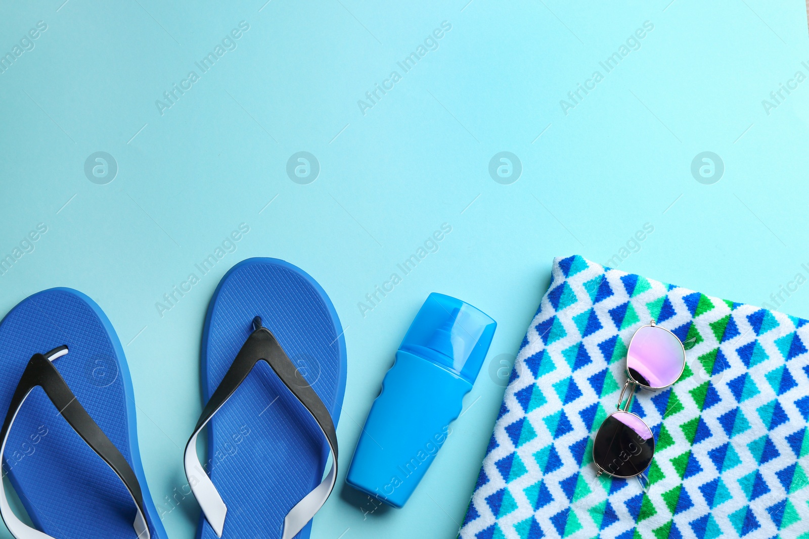 Photo of Flat lay composition with beach accessories on color background. Space for text