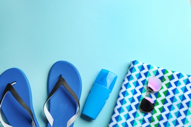 Flat lay composition with beach accessories on color background. Space for text