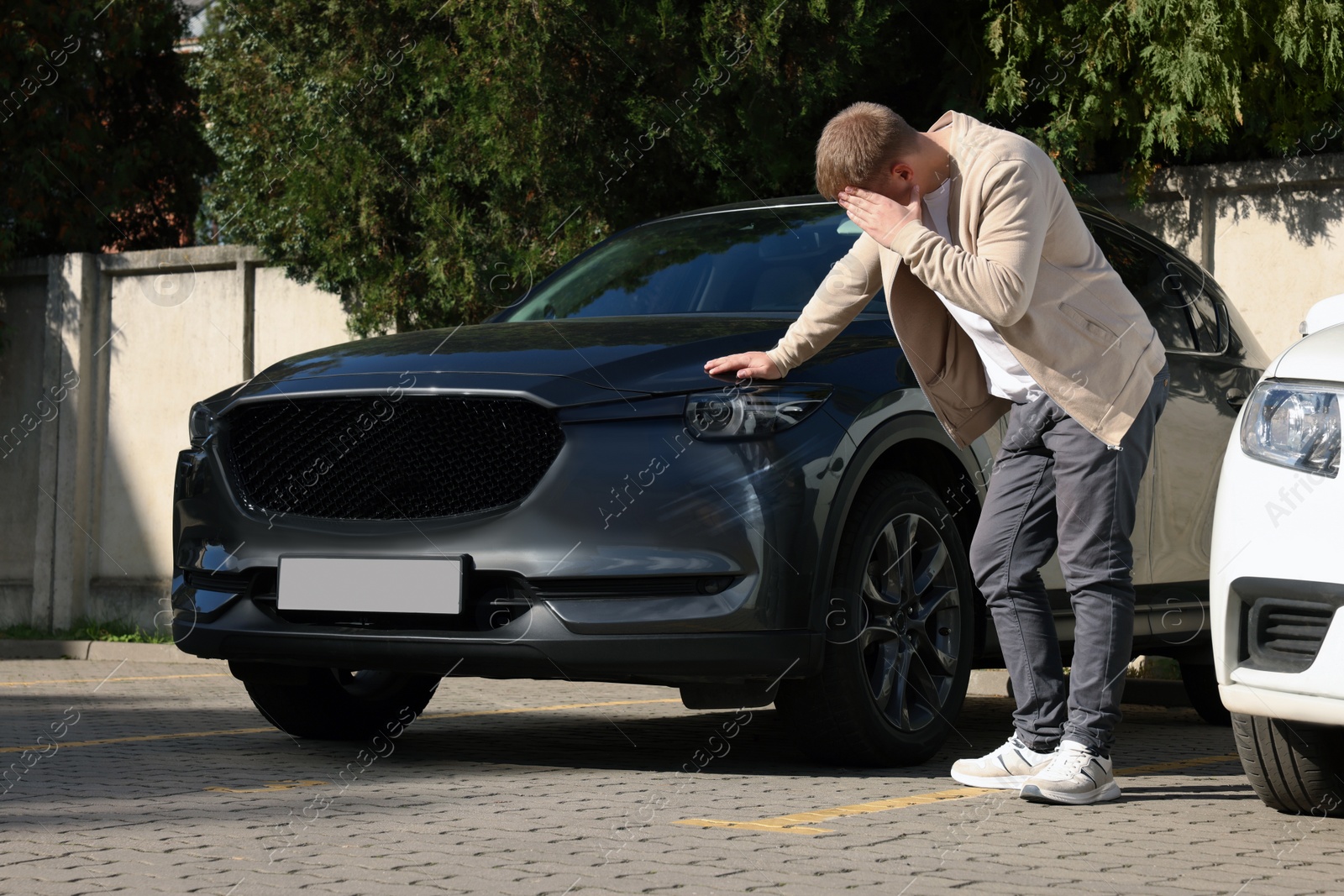 Photo of Stressed man near car with scratch outdoors