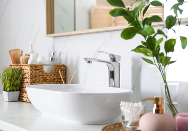 Modern vessel sink with faucet in stylish bathroom