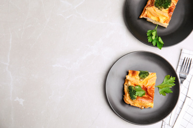 Photo of Tasty broccoli casserole served on grey marble table, flat lay. Space for text