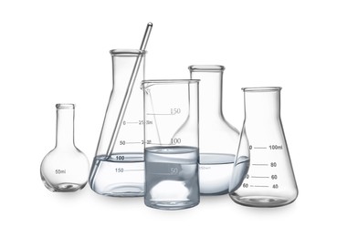 Different empty laboratory glassware with water and stirring rod isolated on white