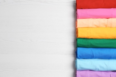 Photo of Colorful collection of  t-shirts on light background