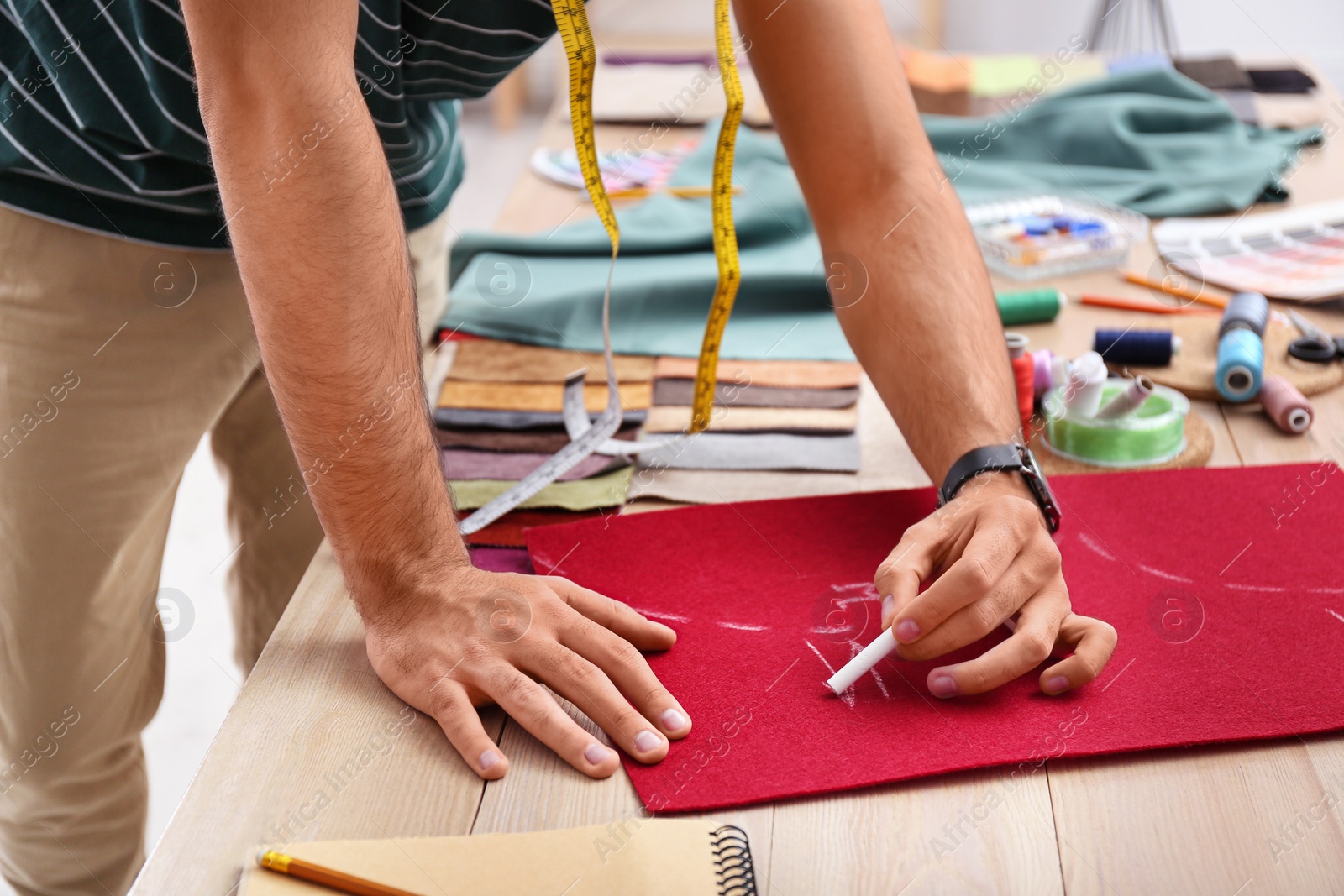 Photo of Fashion designer creating new clothes in studio, closeup