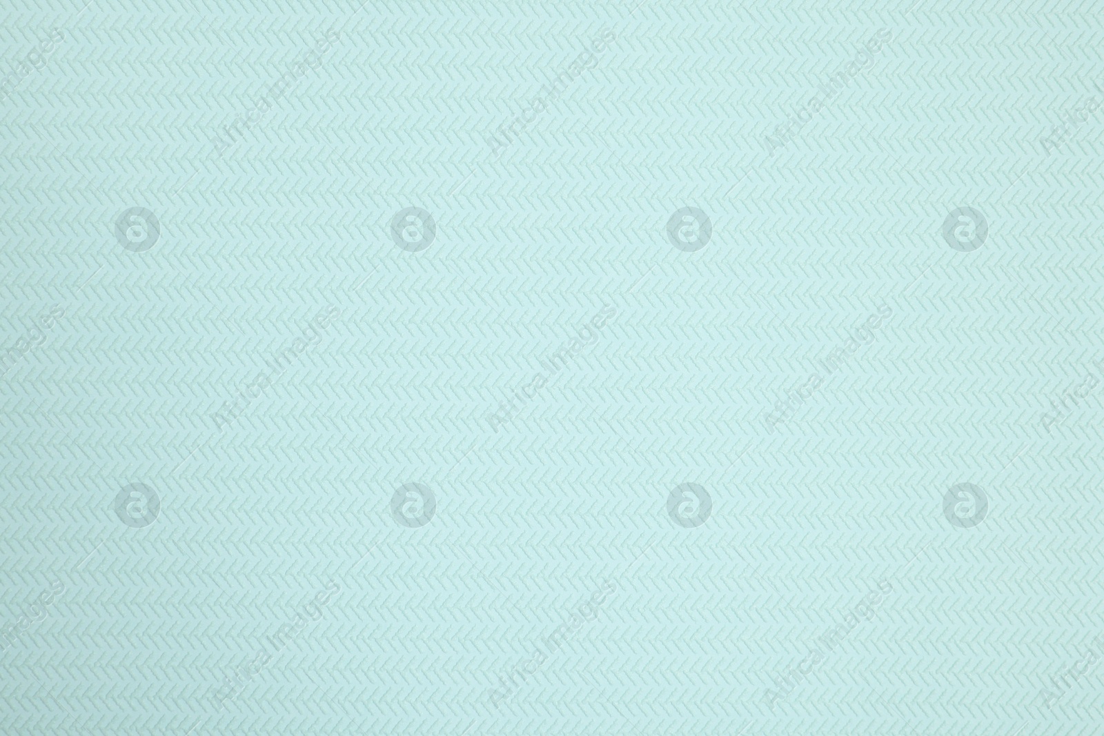 Photo of Stylish light turquoise wallpaper as background, closeup