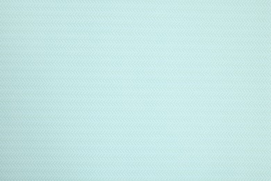 Photo of Stylish light turquoise wallpaper as background, closeup