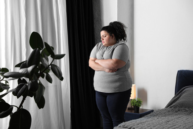 Photo of Overweight woman suffering from depression at home
