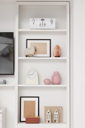 Shelves with different decor indoors. Interior design