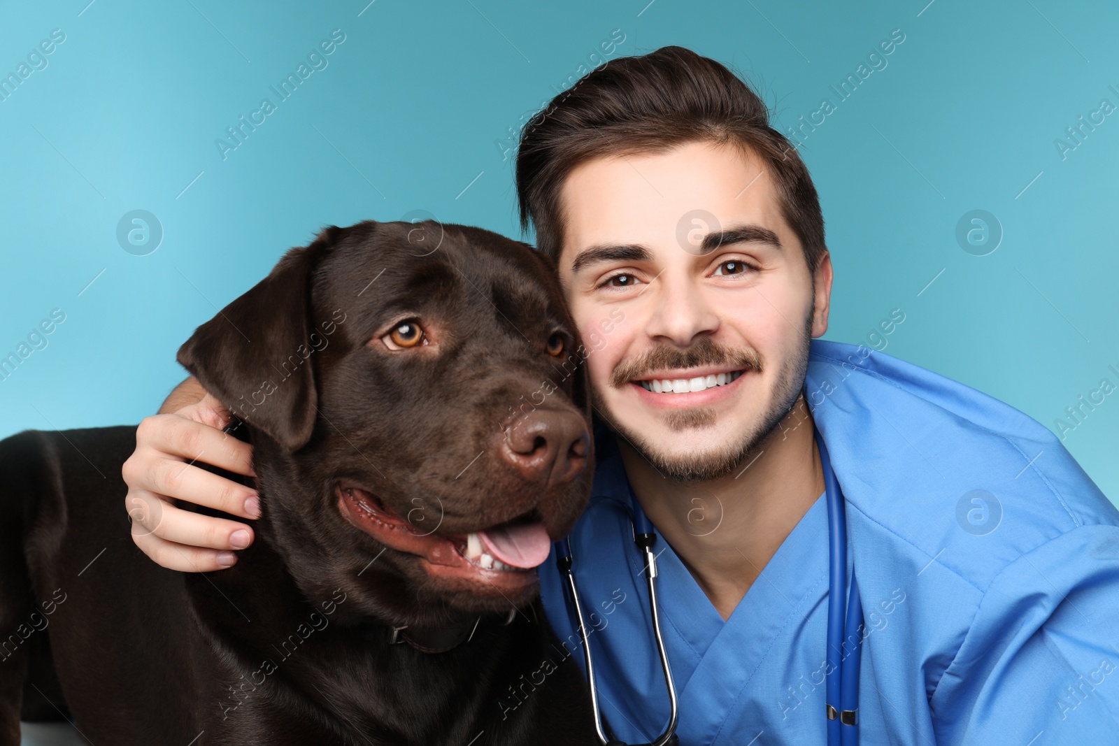 Photo of Veterinarian doc with dog on color background