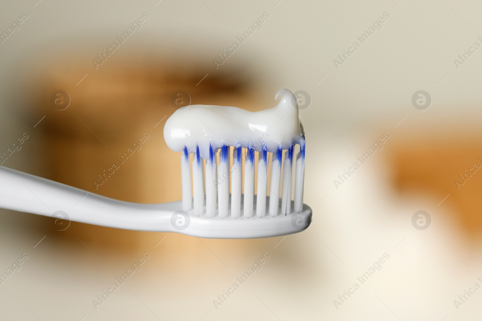 Photo of Plastic toothbrush with paste on blurred background, closeup