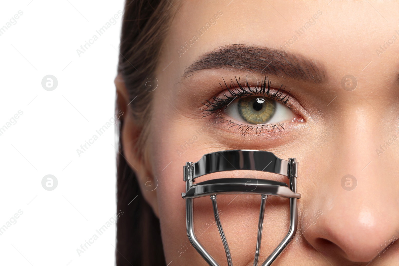 Photo of Woman using eyelash curler on white background, closeup