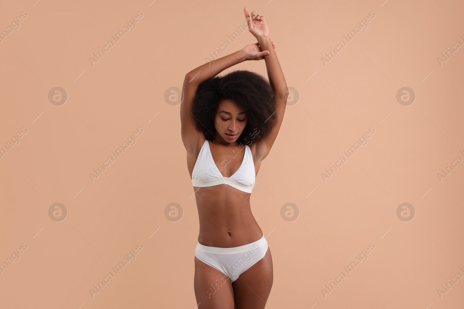 Photo of Beautiful woman in stylish bikini on beige background