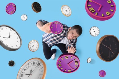 Deadline management. Man evading falling clocks on light blue background, above view