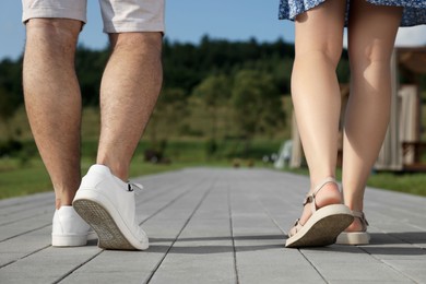 Photo of Romantic date. Couple walking outdoors, closeup view