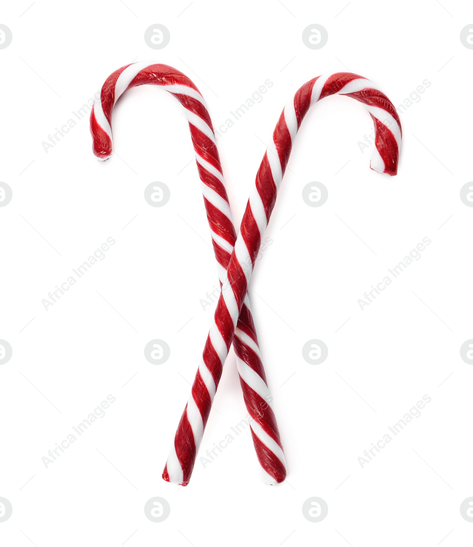 Photo of Delicious Christmas candy canes on white background, top view