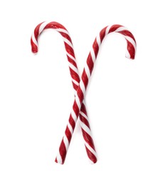 Photo of Delicious Christmas candy canes on white background, top view