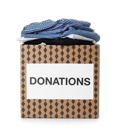 Donation box with clothes on white background