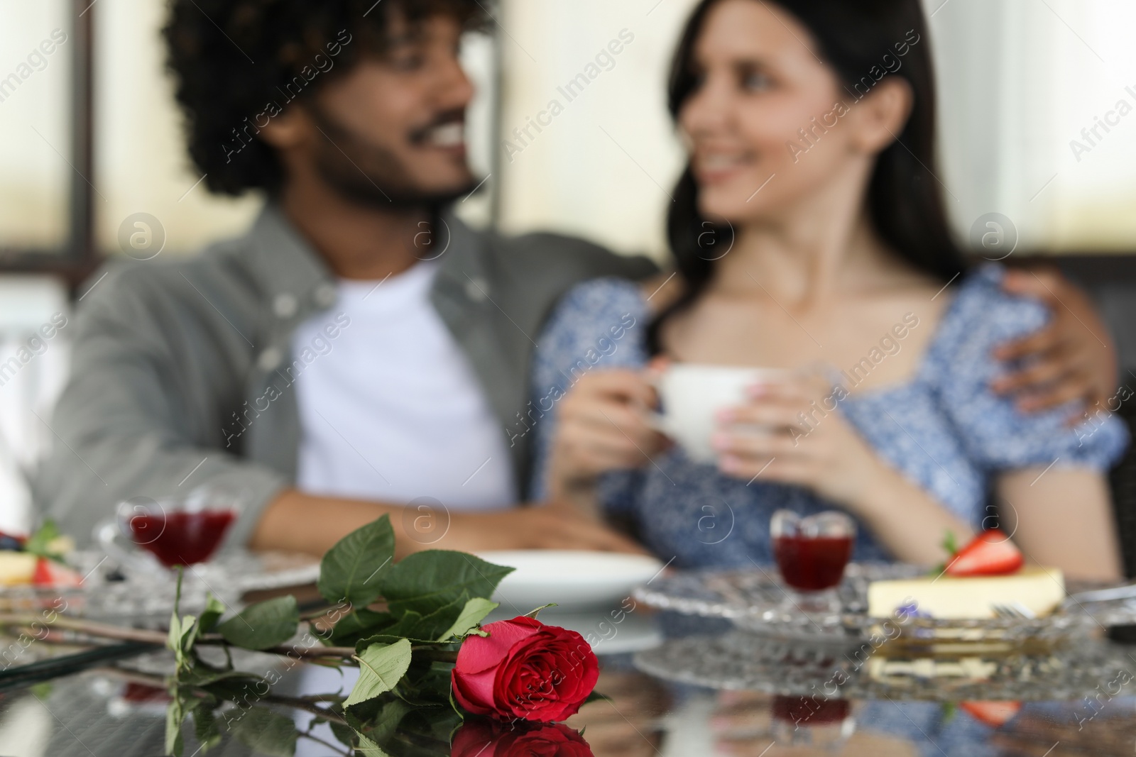 Photo of International dating. Happy couple spending time together in restaurant, selective focus