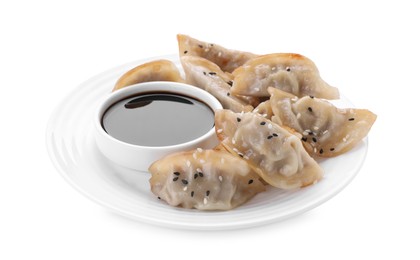 Photo of Delicious gyoza (asian dumplings) and soy sauce isolated on white