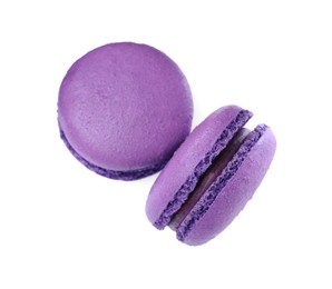 Photo of Delicious purple macarons on white background, top view