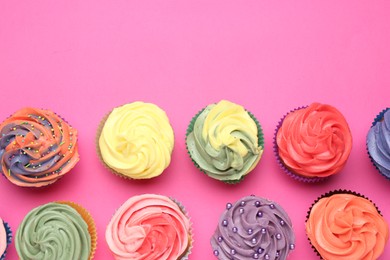 Photo of Delicious cupcake with bright cream on pink background, flat lay