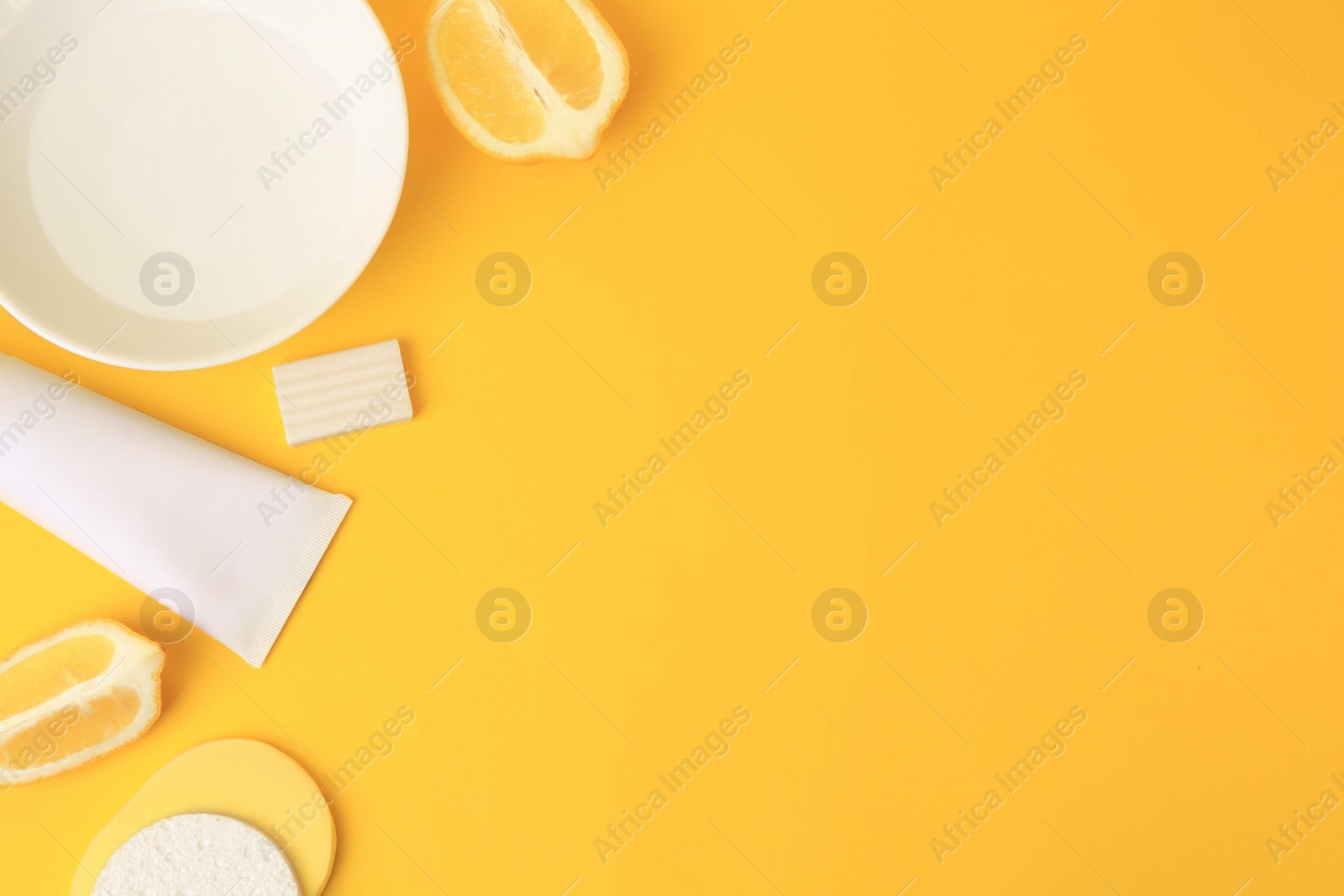 Photo of Lemon face wash. Fresh citrus fruits and personal care products on yellow background, flat lay with space for text