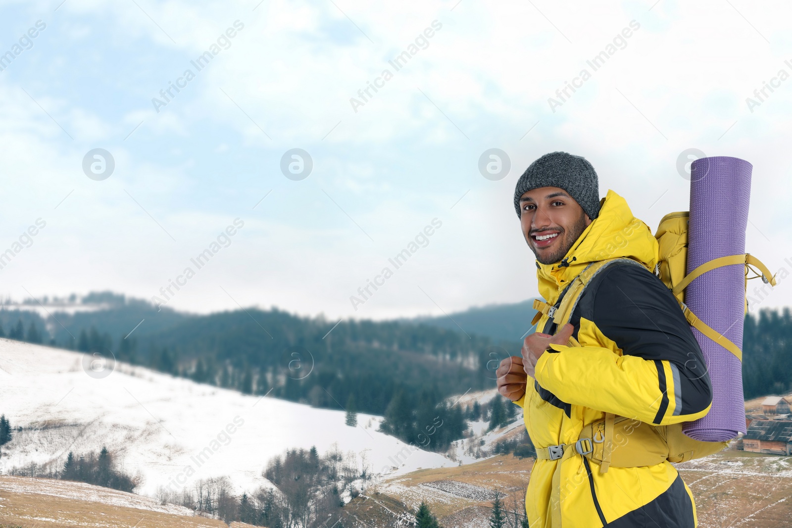 Image of Happy tourist with backpack in snowy mountains