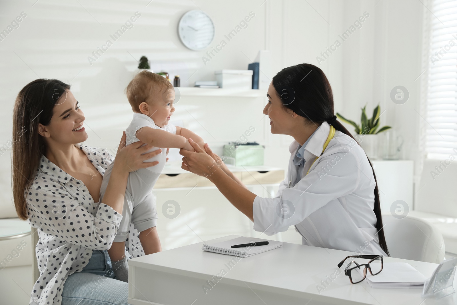 Photo of Mother with her cute baby visiting pediatrician in clinic