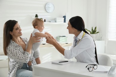 Mother with her cute baby visiting pediatrician in clinic