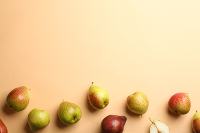 Photo of Ripe juicy pears on beige background, flat lay. Space for text