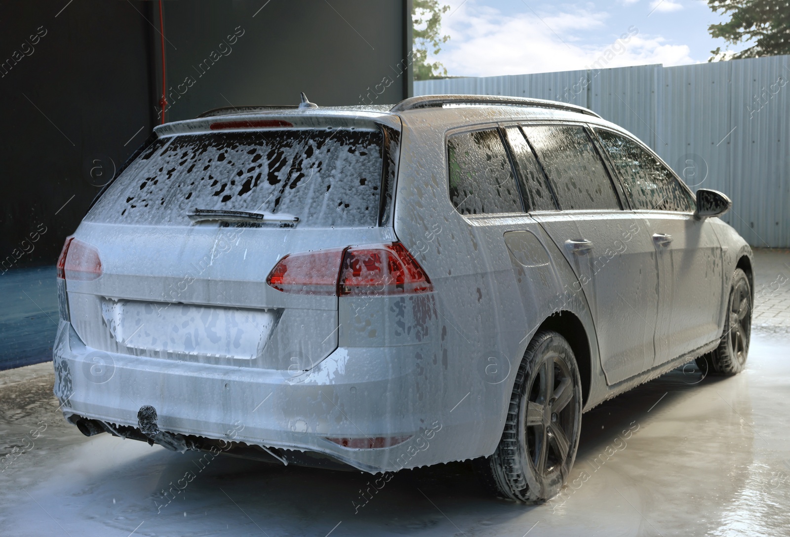 Photo of Auto with cleaning foam at outdoor car wash