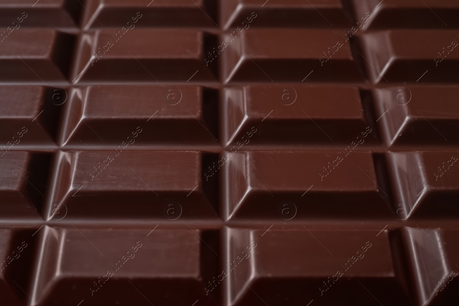 Photo of Delicious dark chocolate bar as background, closeup