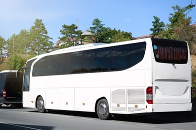 Photo of Modern white bus on road outdoors. Public transport