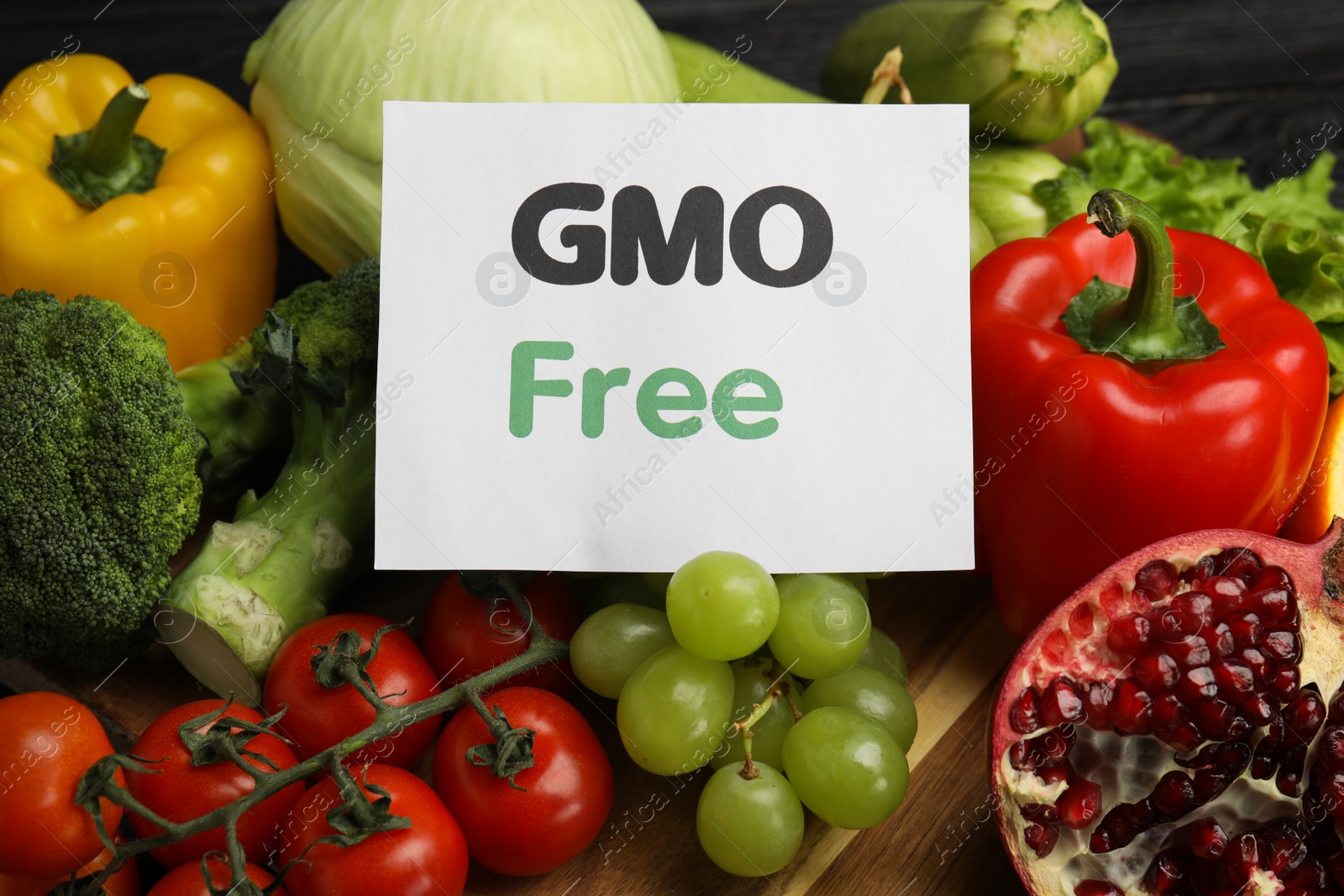 Photo of Tasty fresh GMO free products and paper card, closeup