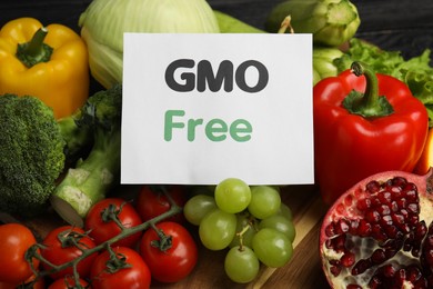 Tasty fresh GMO free products and paper card, closeup