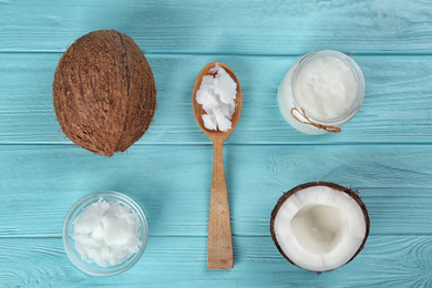 Photo of Flat lay composition with organic coconut oil on light blue wooden table. Healthy cooking