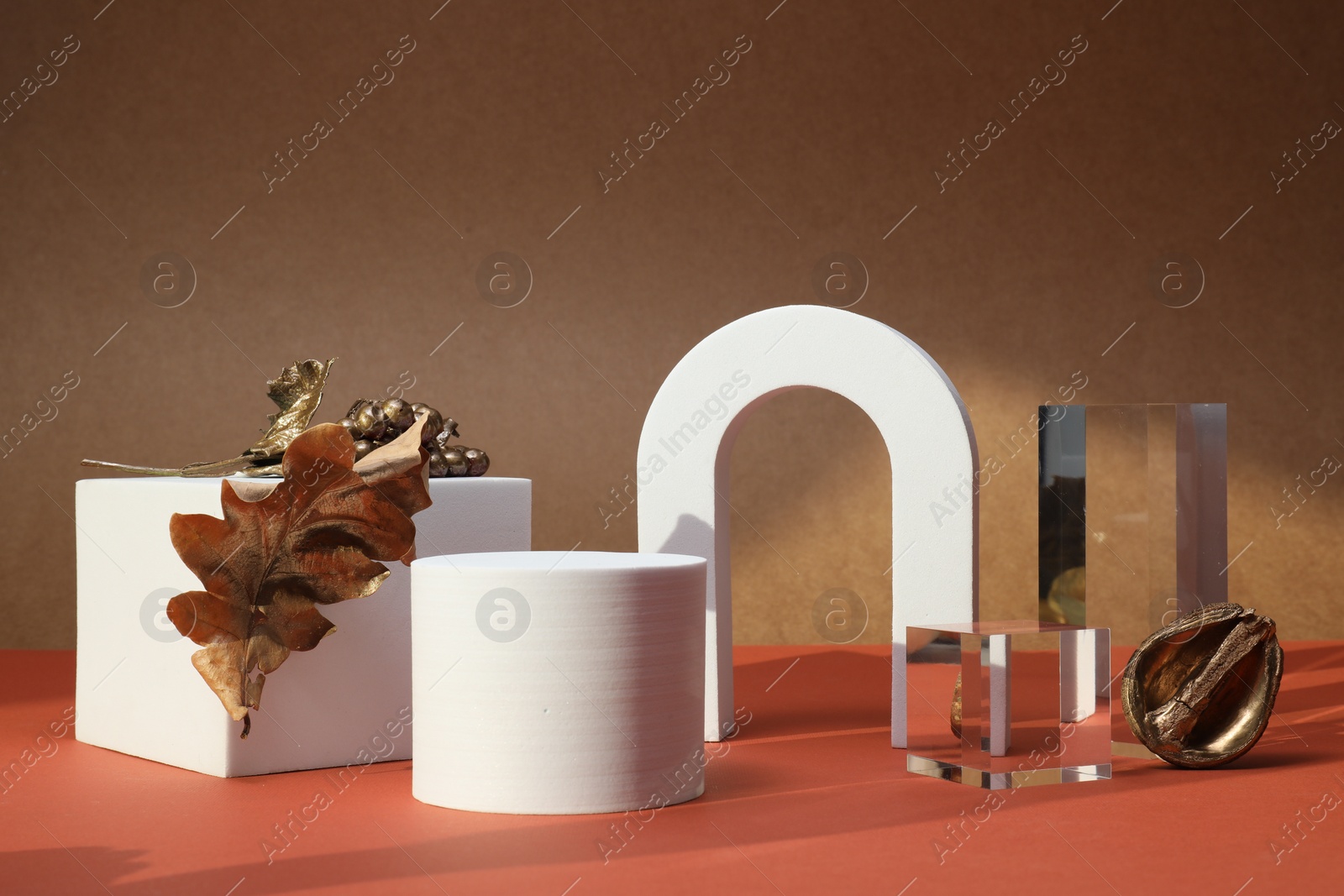Photo of Autumn presentation for product. Geometric figures and golden decorative elements on color background