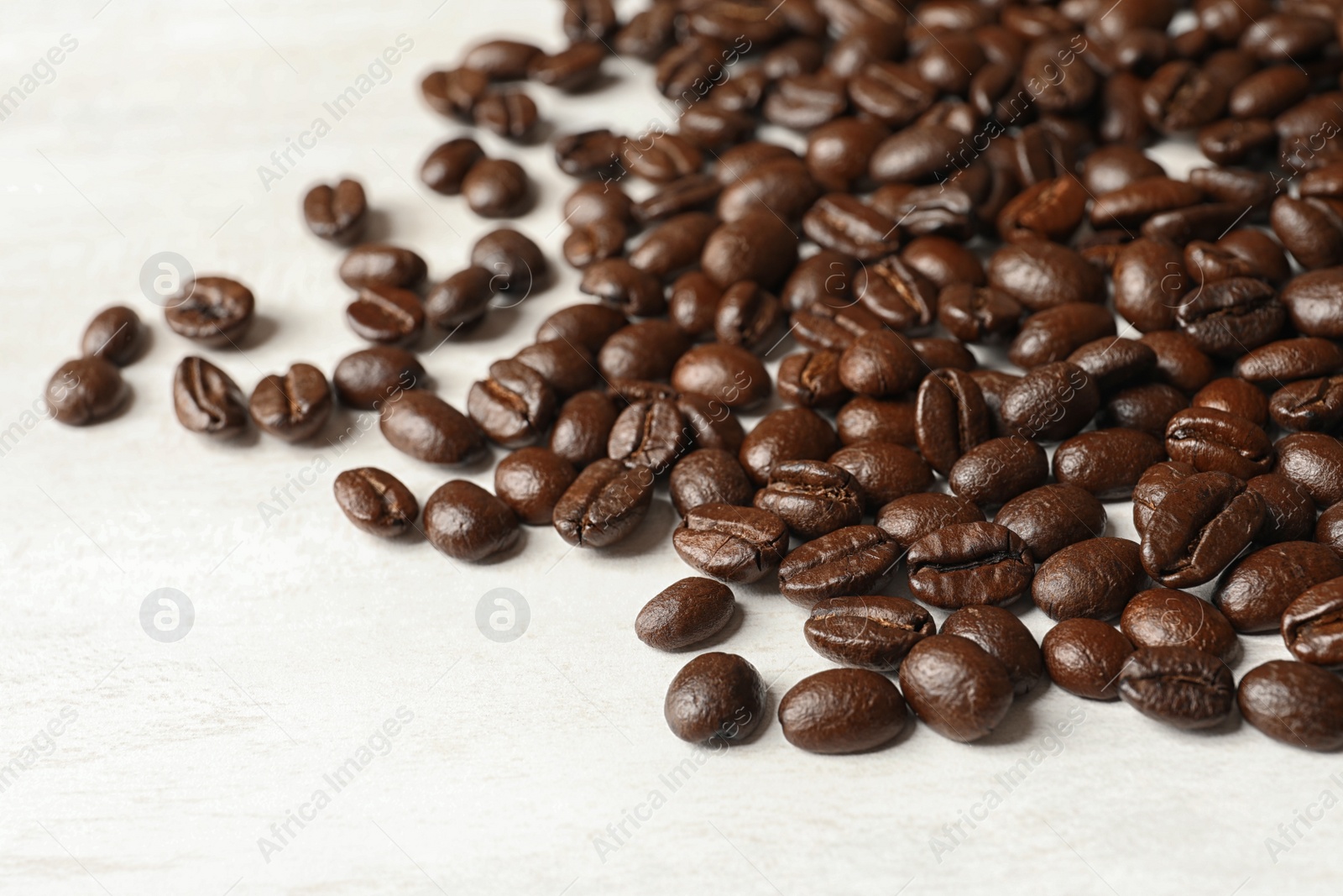 Photo of Roasted coffee beans on white background, closeup