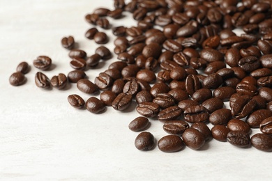 Roasted coffee beans on white background, closeup