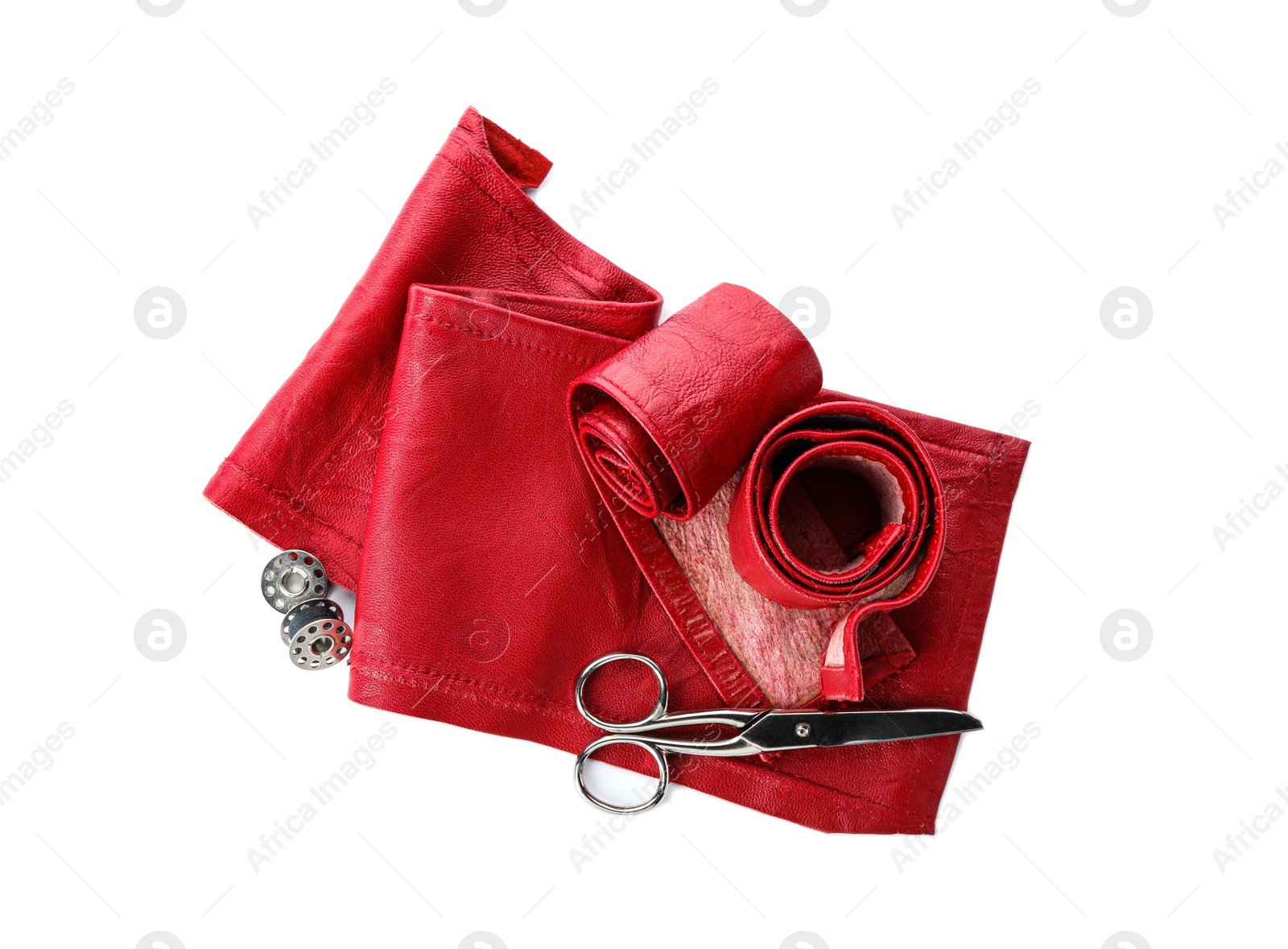 Photo of Red leather samples and craftsman tools isolated on white, top view