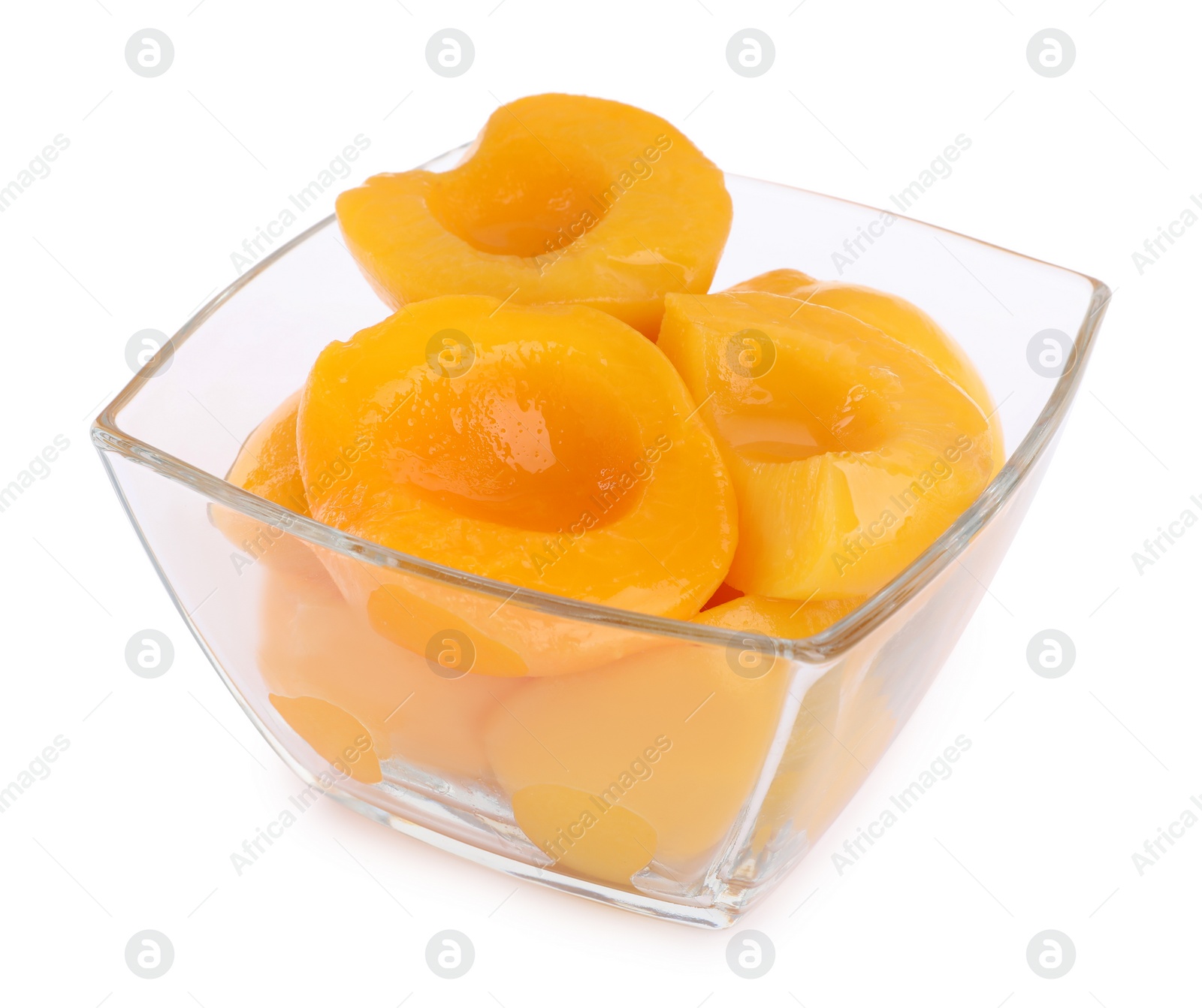 Photo of Halves of canned peaches in bowl isolated on white