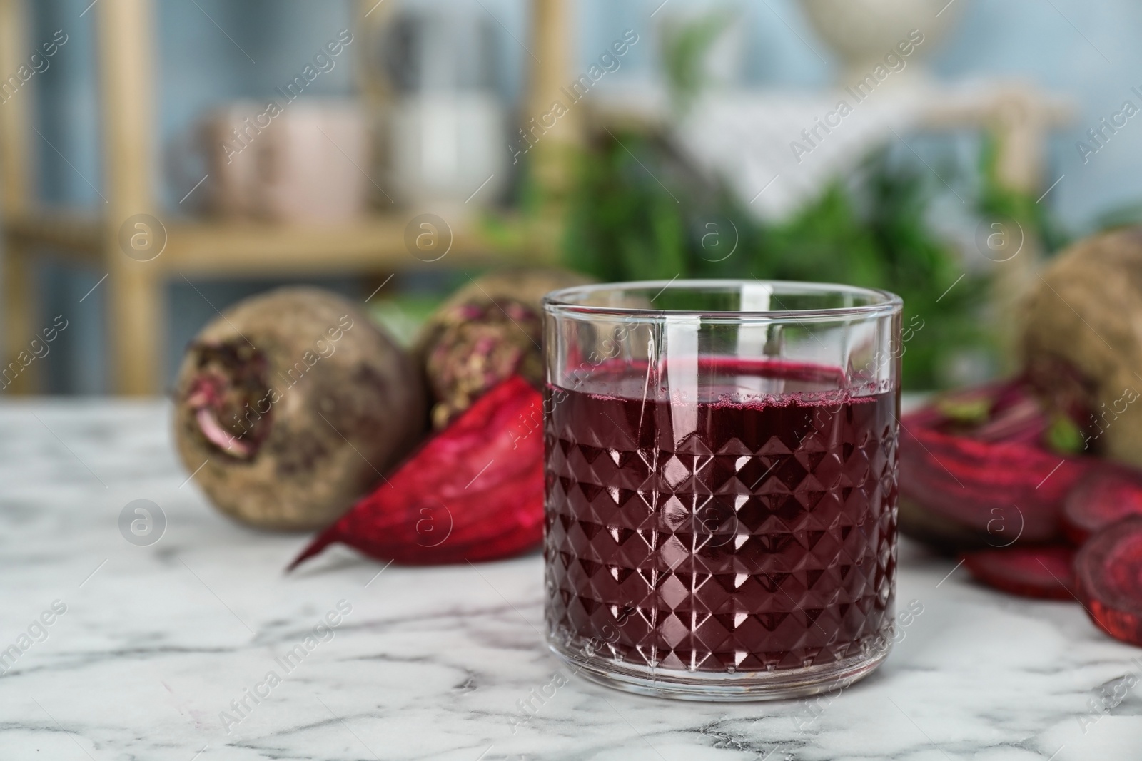 Photo of Glass with fresh healthy beet juice on table