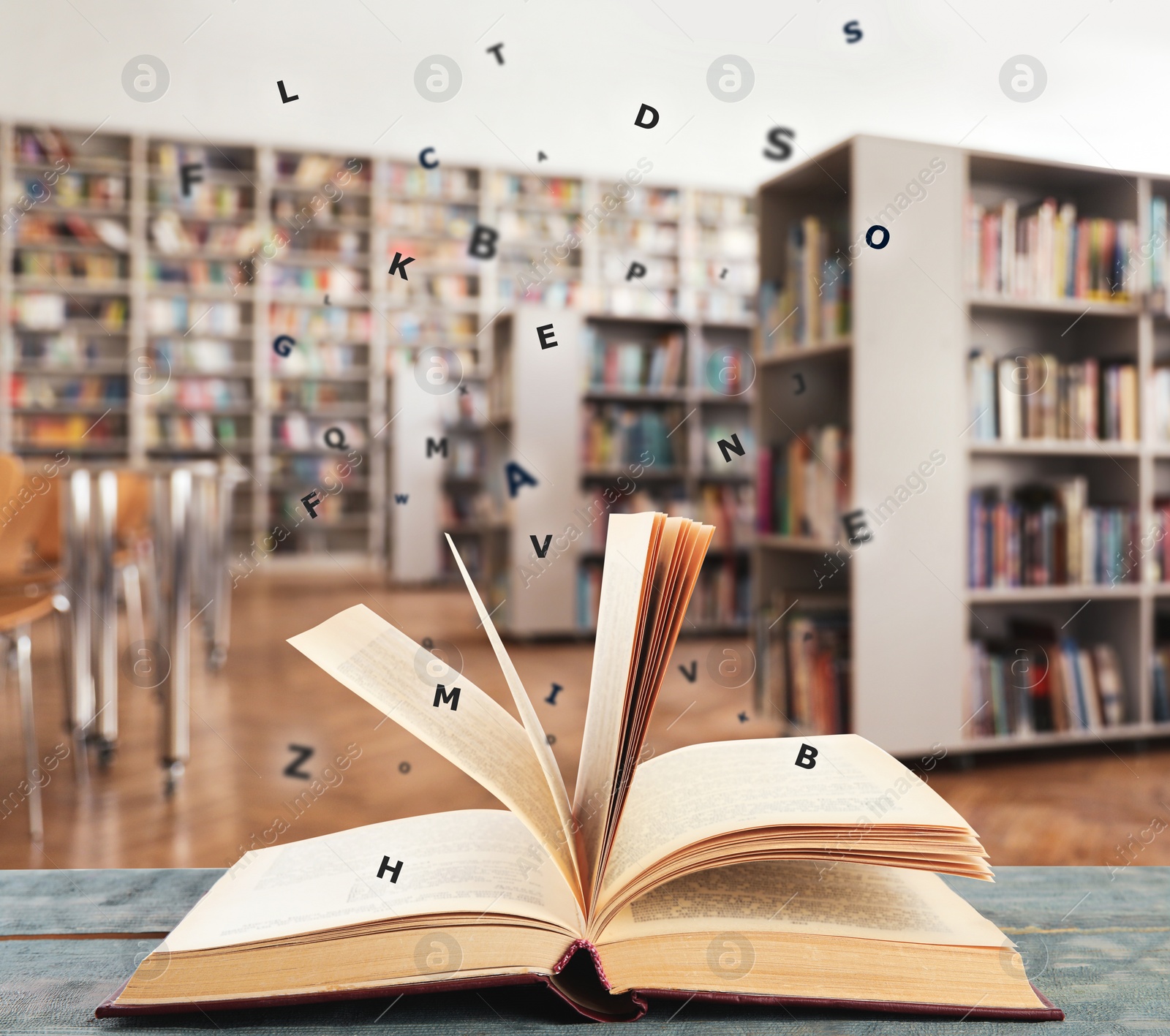 Image of Open book with letters flying out of it in library